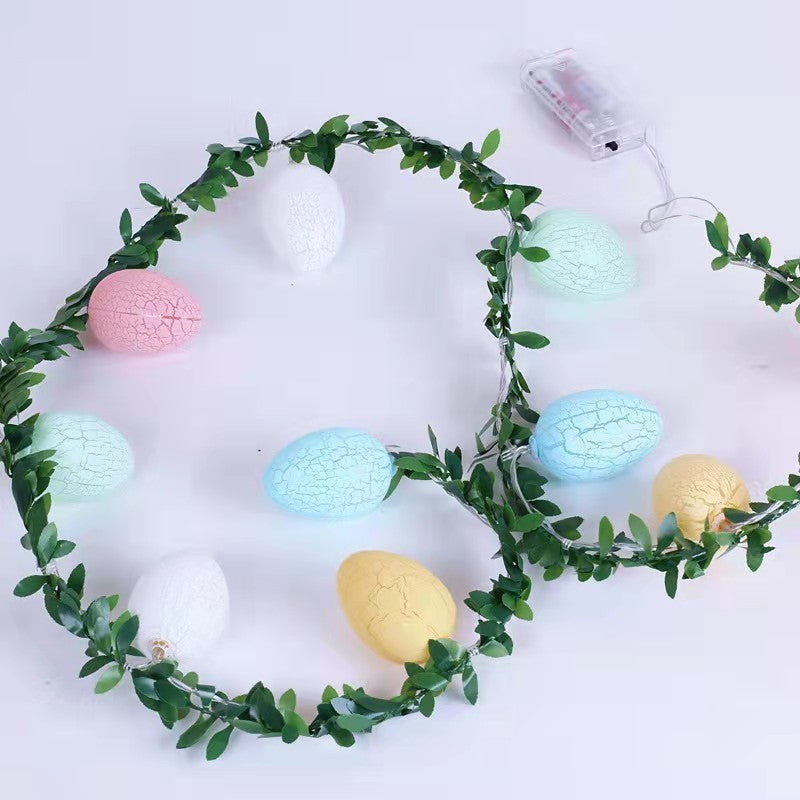 Easter egg-shaped string lights with warm glowing colors, wrapped in green leaf rattan, creating a cozy and festive ambiance for home decor.