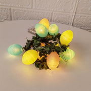 Softly illuminated Easter-themed string lights with colorful egg-shaped bulbs and rattan leaves, ideal for decorating living spaces, patios, or Easter celebrations.